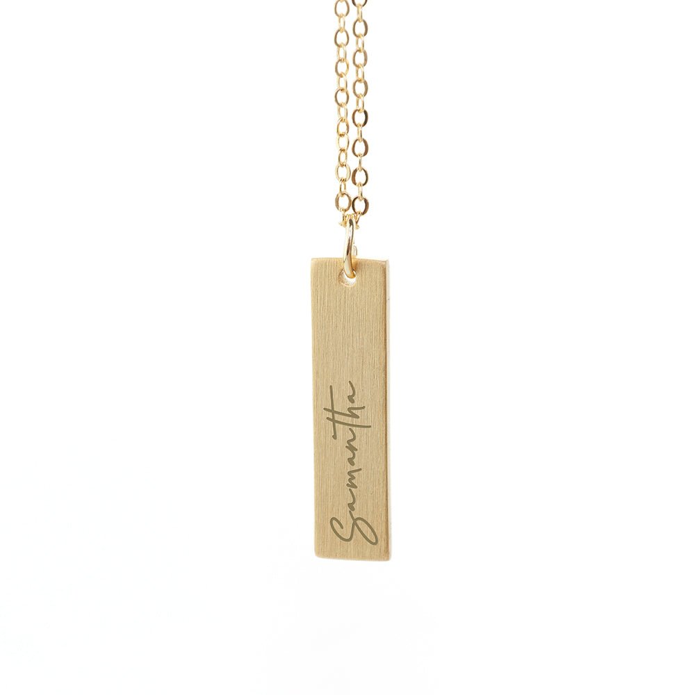 Gold bar pendant necklace engraved with a loved one's handwriting. A sentimental, stylish gift. Length: 3cm.