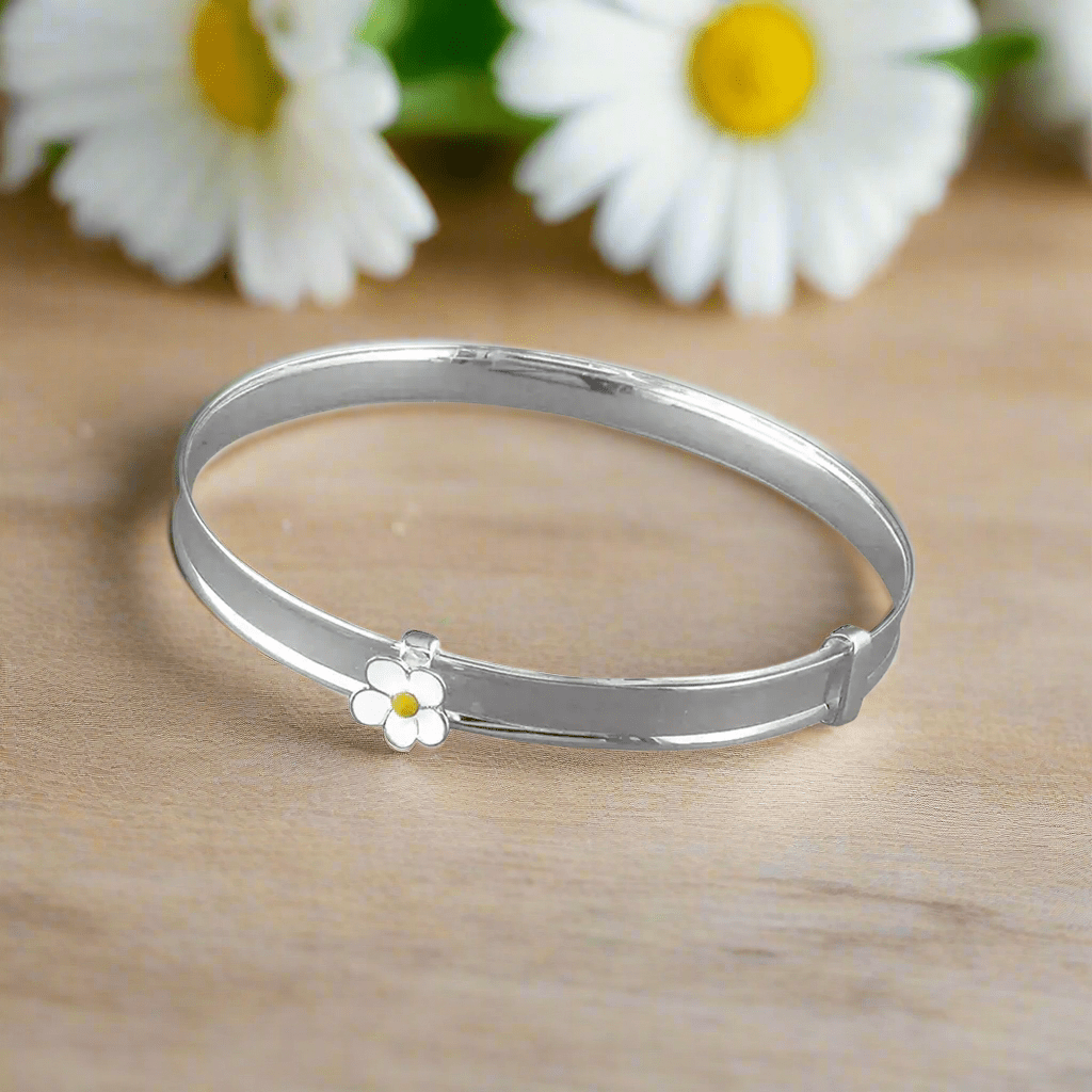 Sterling silver baby bangle with enamel daisy, heart, or crown. Expandable, engravable, perfect keepsake.